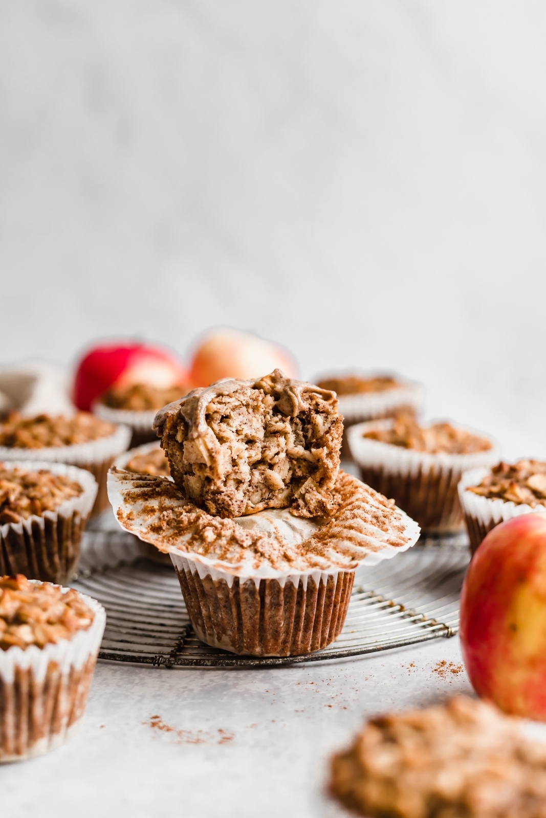 two apple cinnamon baked oatmeal cups in a stack with a bite taken out