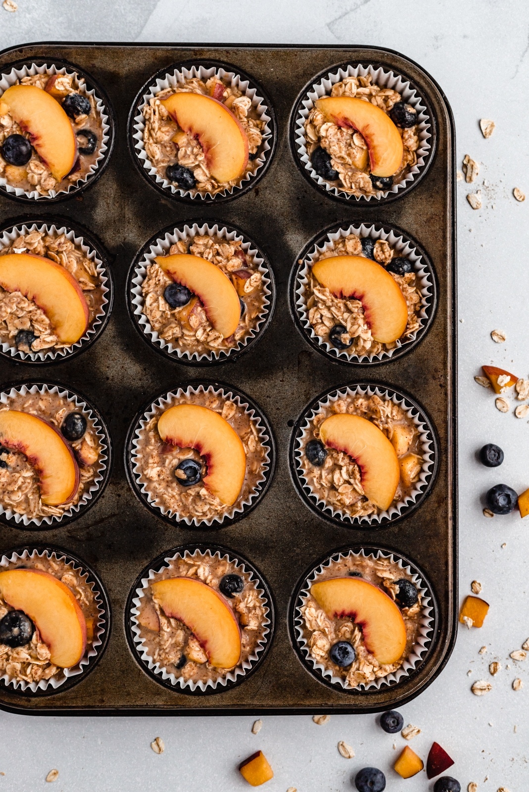 almond butter peach oatmeal cups in a muffin tin