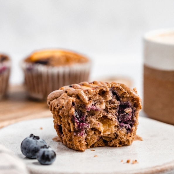 healthy blueberry peach baked oatmeal cup with a bite taken out