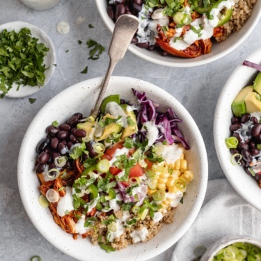 bbq chicken quinoa bowl with avocado, black beans, corn and cabbage