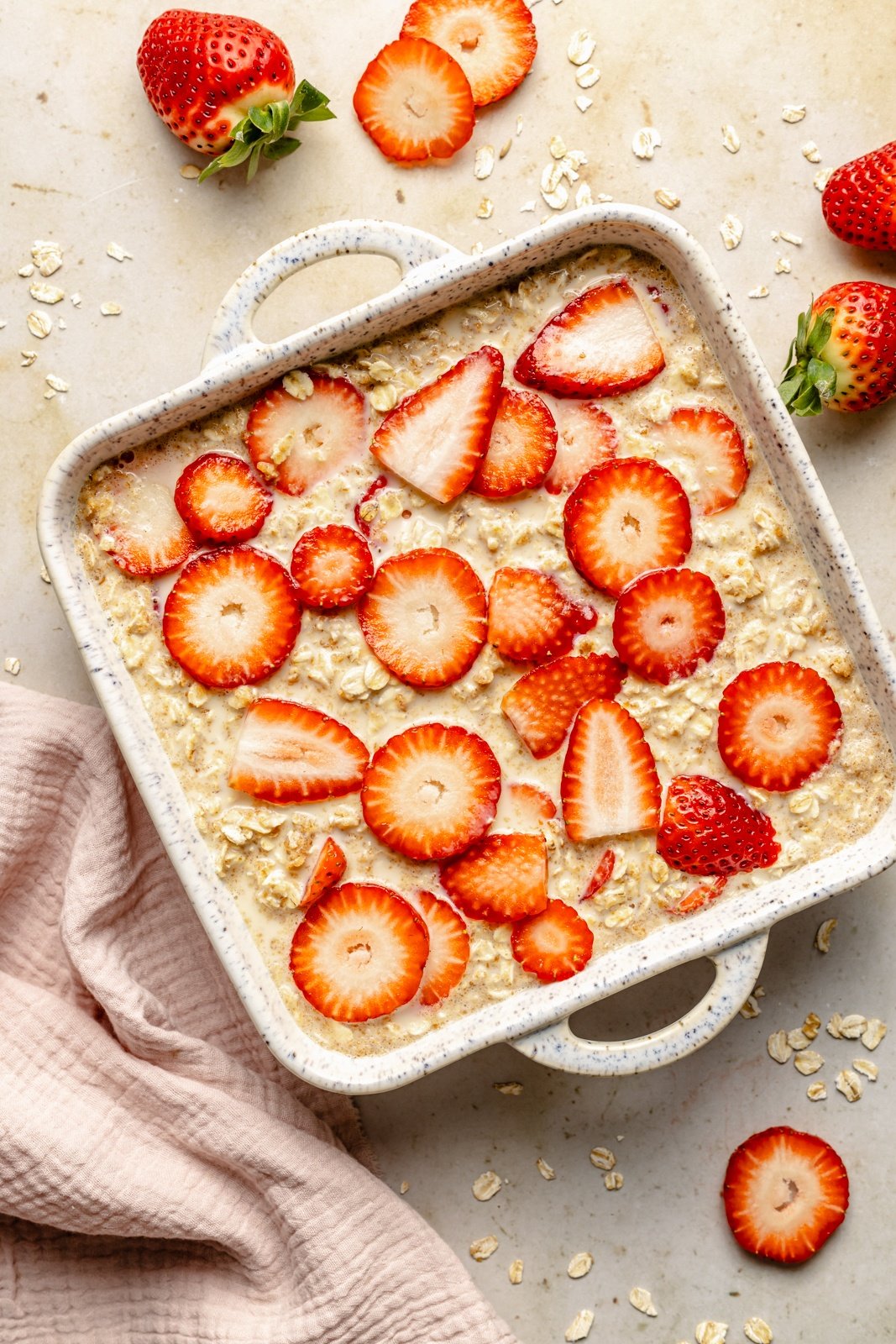 unbaked strawberry baked oatmeal in a pan