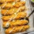 mac and cheese stuffed zucchini on a baking sheet