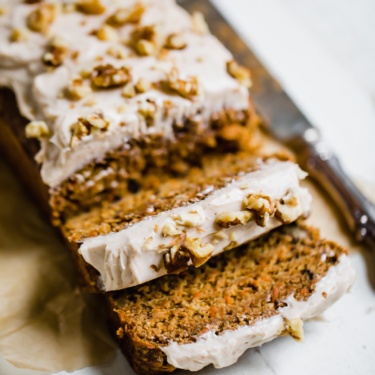 carrot cake banana bread sliced on parchment paper