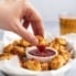 dipping a gluten free cauliflower tot in ketchup