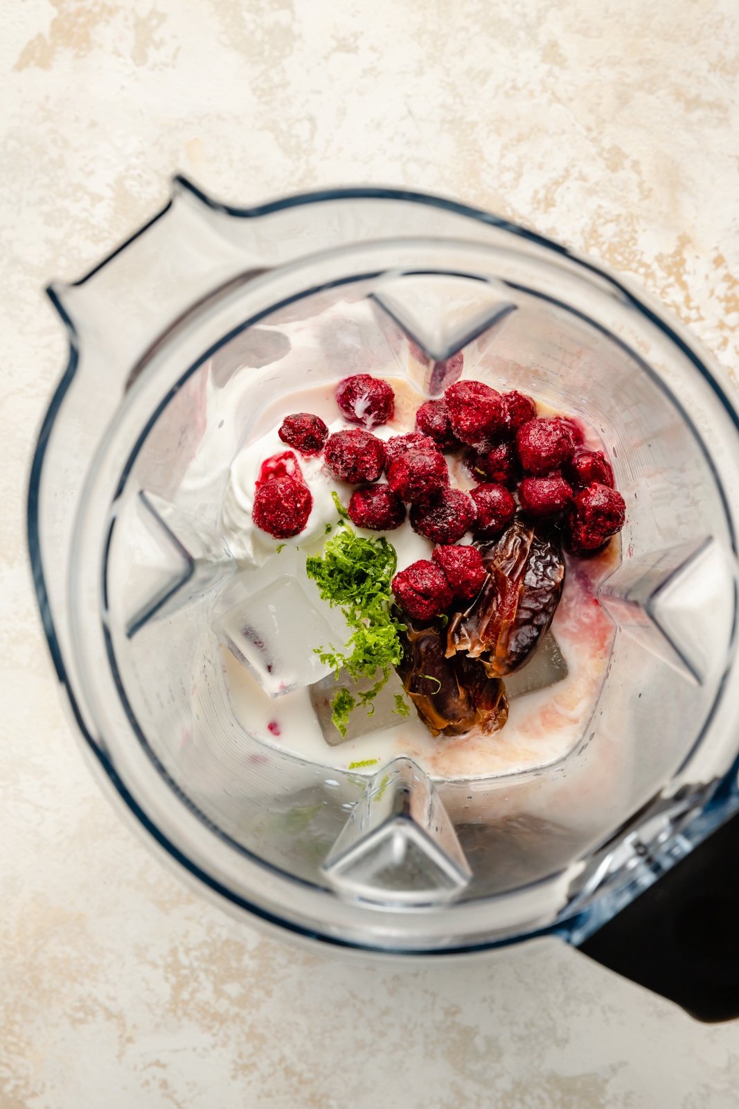 cherry limeade smoothie ingredients in a blender