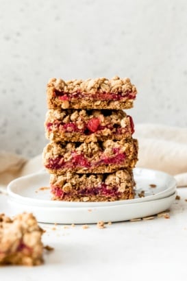 four tart cherry pie bars in a stack on a plate