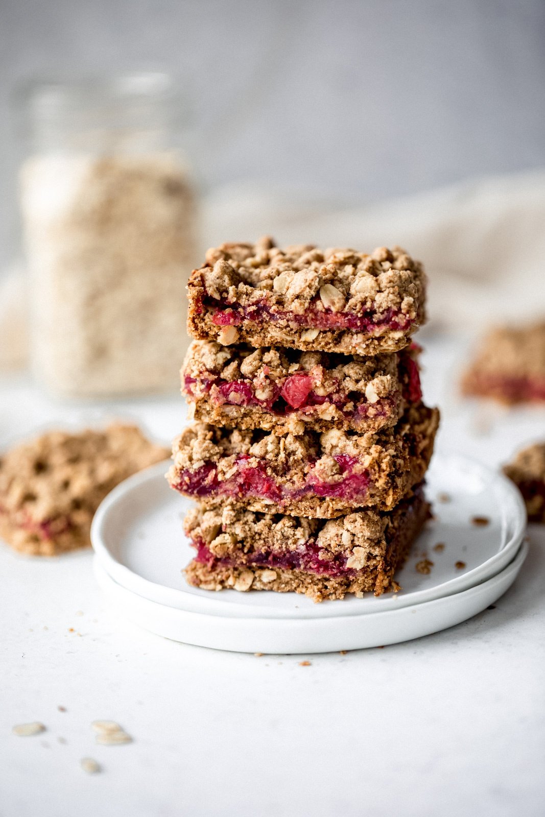 four tart cherry pie bars in a stack on white plates