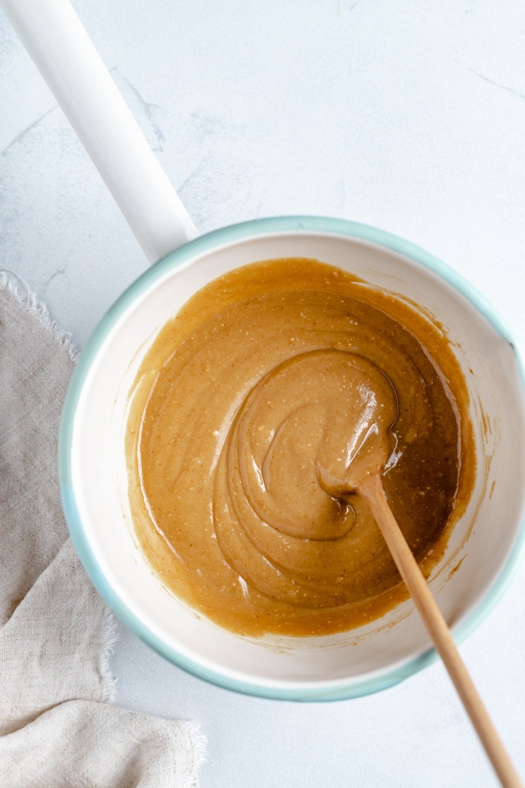 mixing peanut butter to make coconut and chocolate protein bars