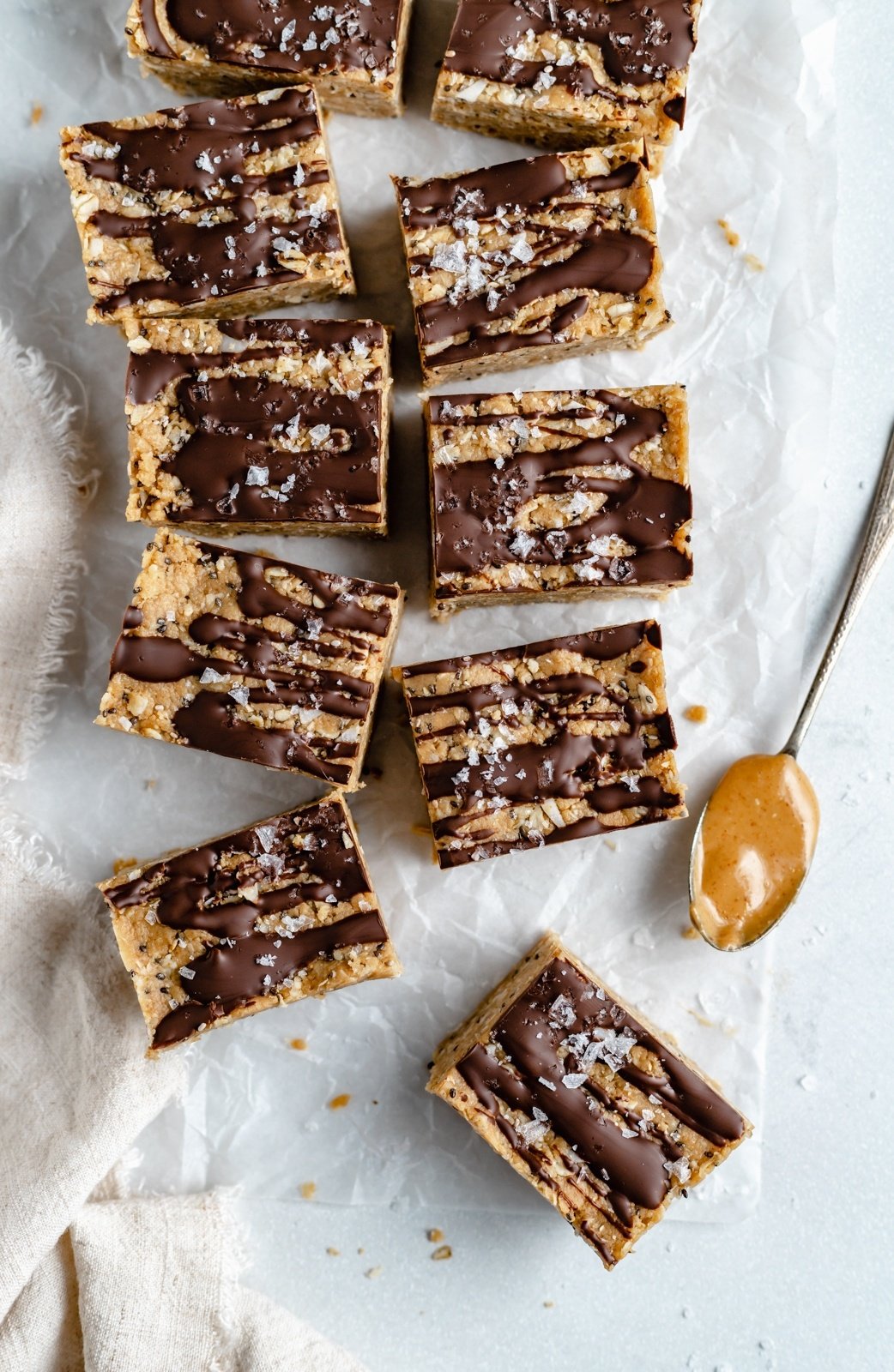 no bake coconut chocolate protein bars on parchment paper