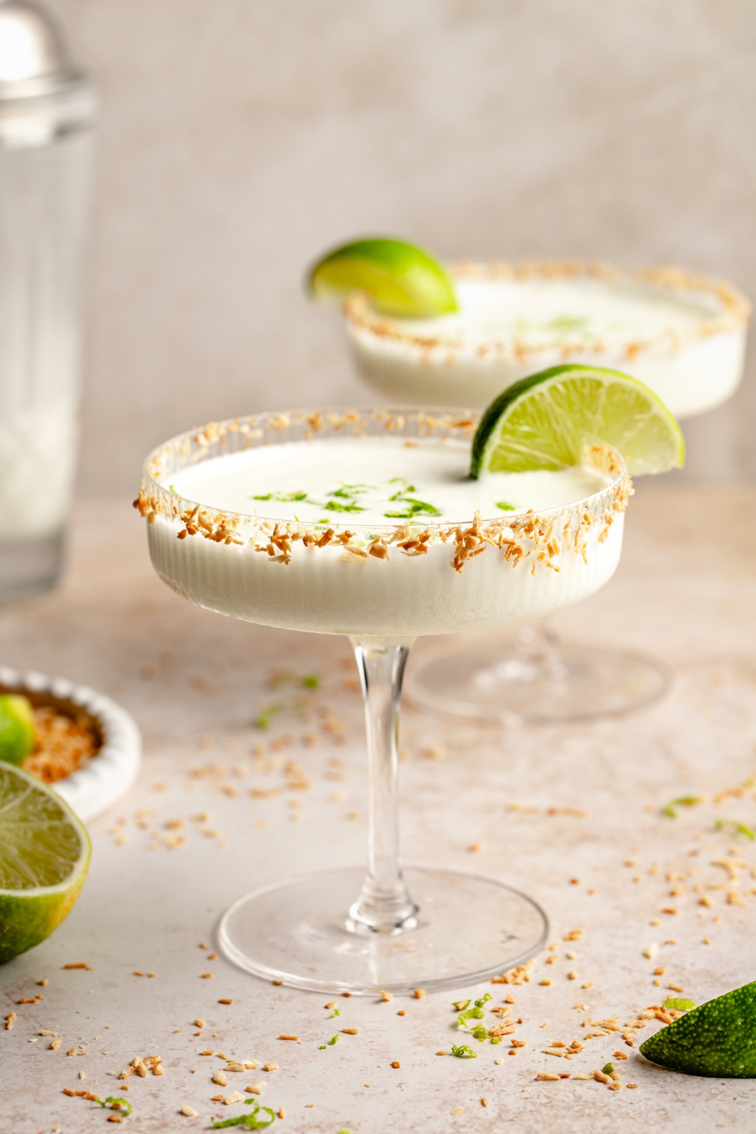 4-ingredient coconut lime margarita in a glass with a lime wedge