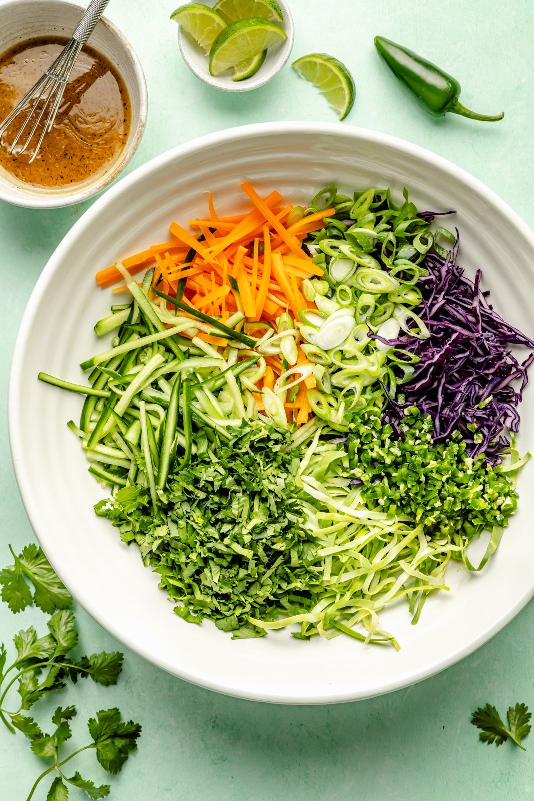 cucumber jalapeño slaw unmixed in a large bowl