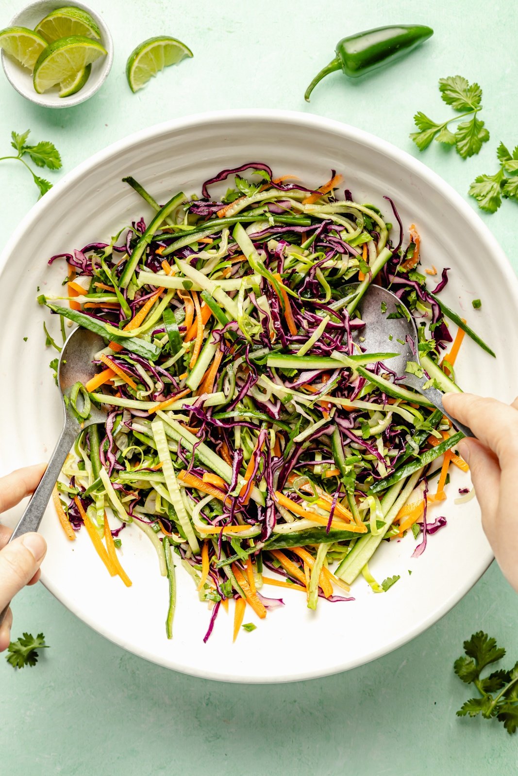 tossing together a cucumber jalapeño slaw