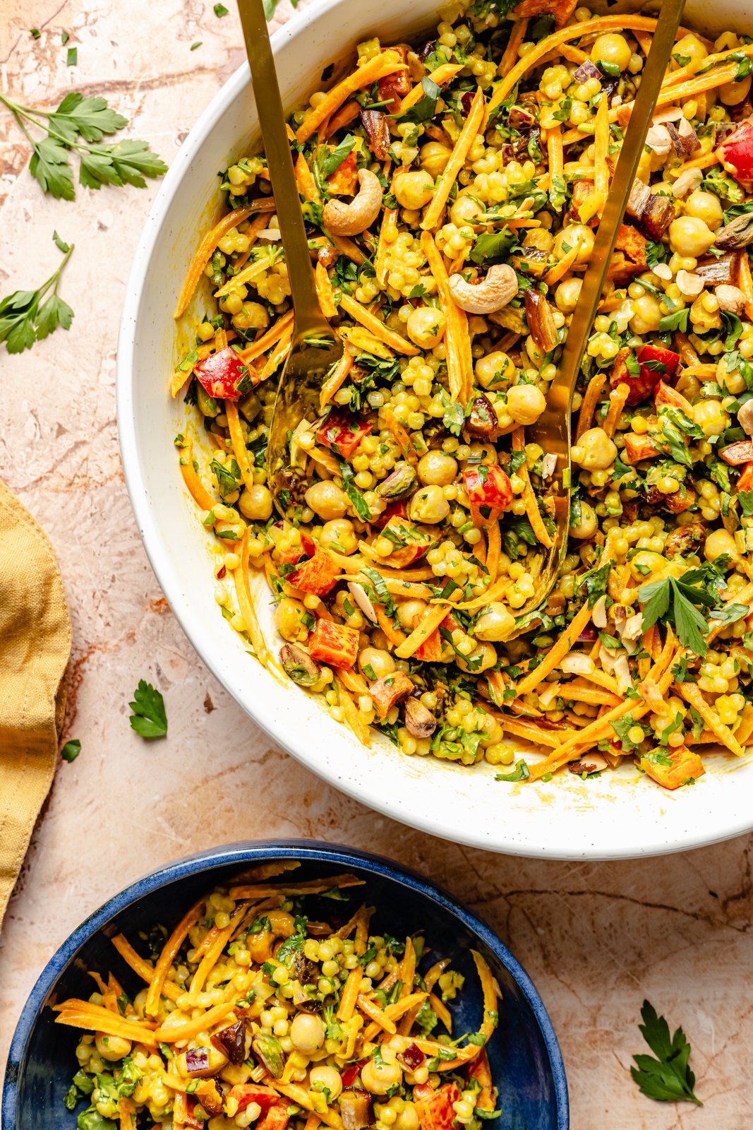 curry chickpea couscous salad in a salad bowl and a serving bowl