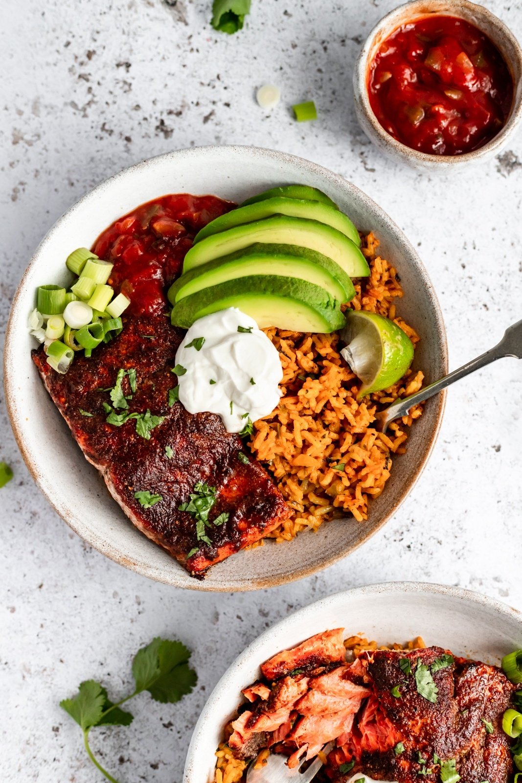 healthy salmon taco bowl topped with avocado and greek yogurt