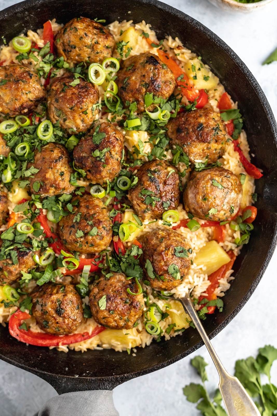 firecracker chicken meatballs in a pan with rice