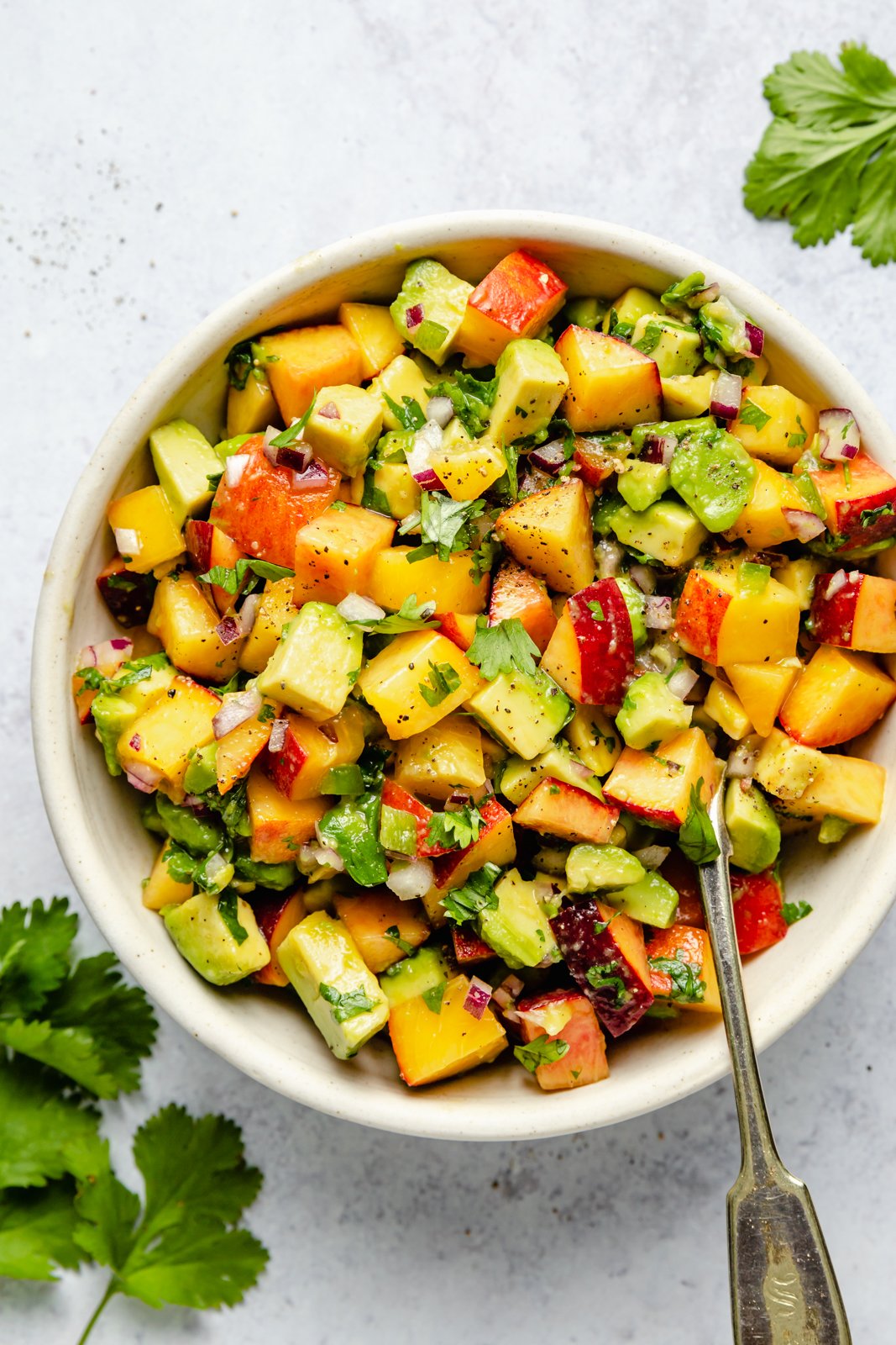 peach avocado salsa in a bowl for firecracker salmon