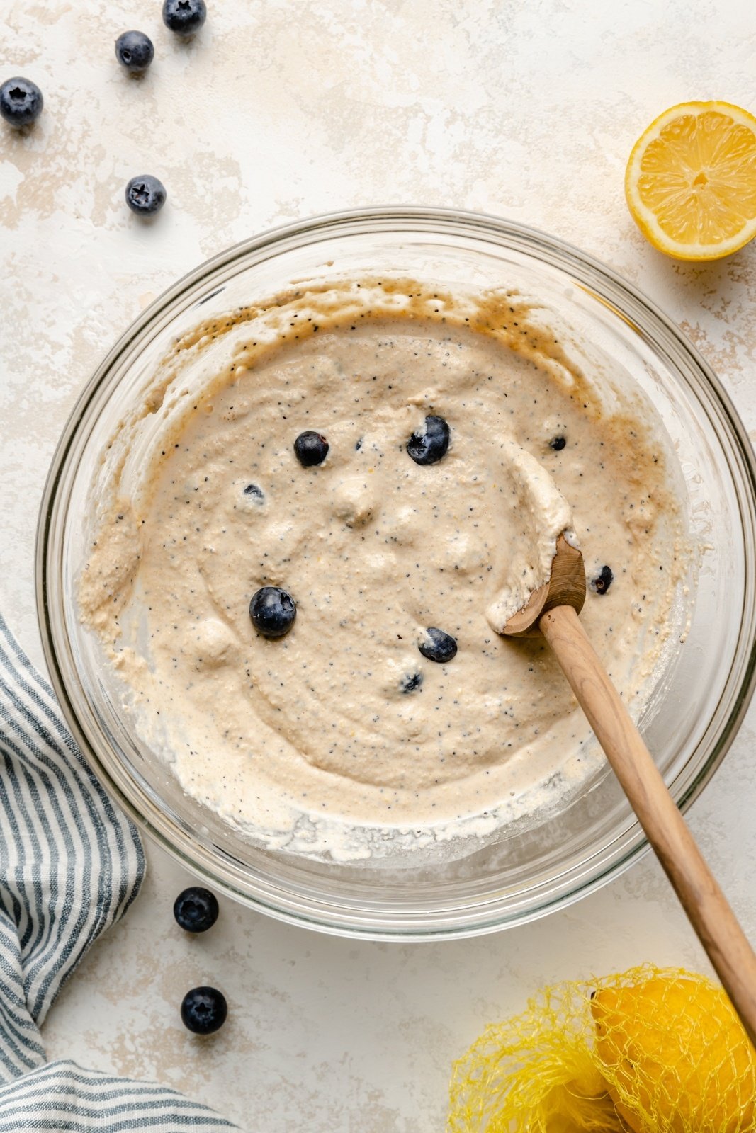 mixing batter for gluten free lemon blueberry pancakes in a bowl