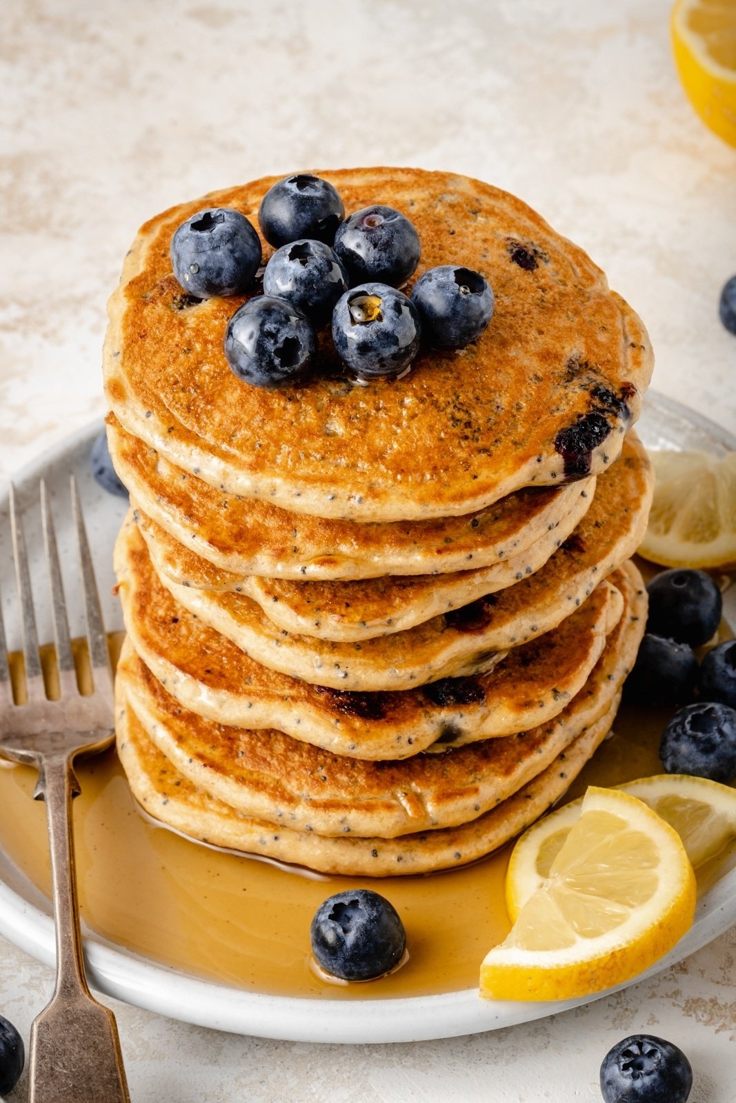 stack of lemon blueberry pancakes with greek yogurt on a plate