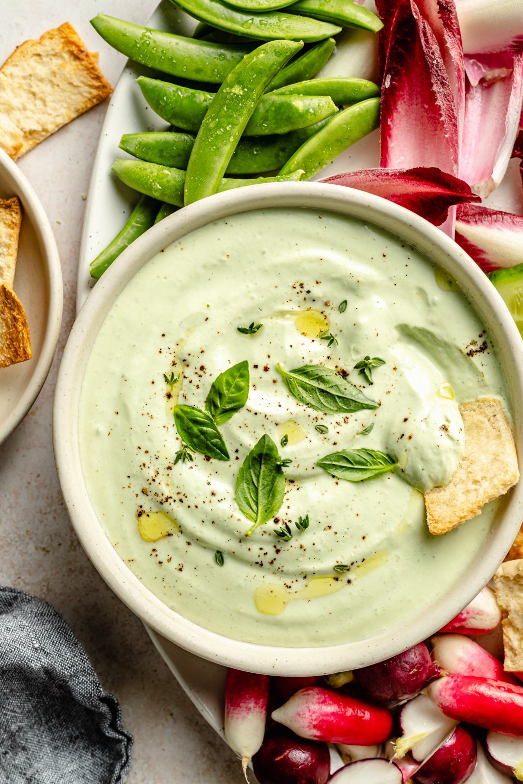 high protein cottage cheese dip in a bowl with a pita cracker