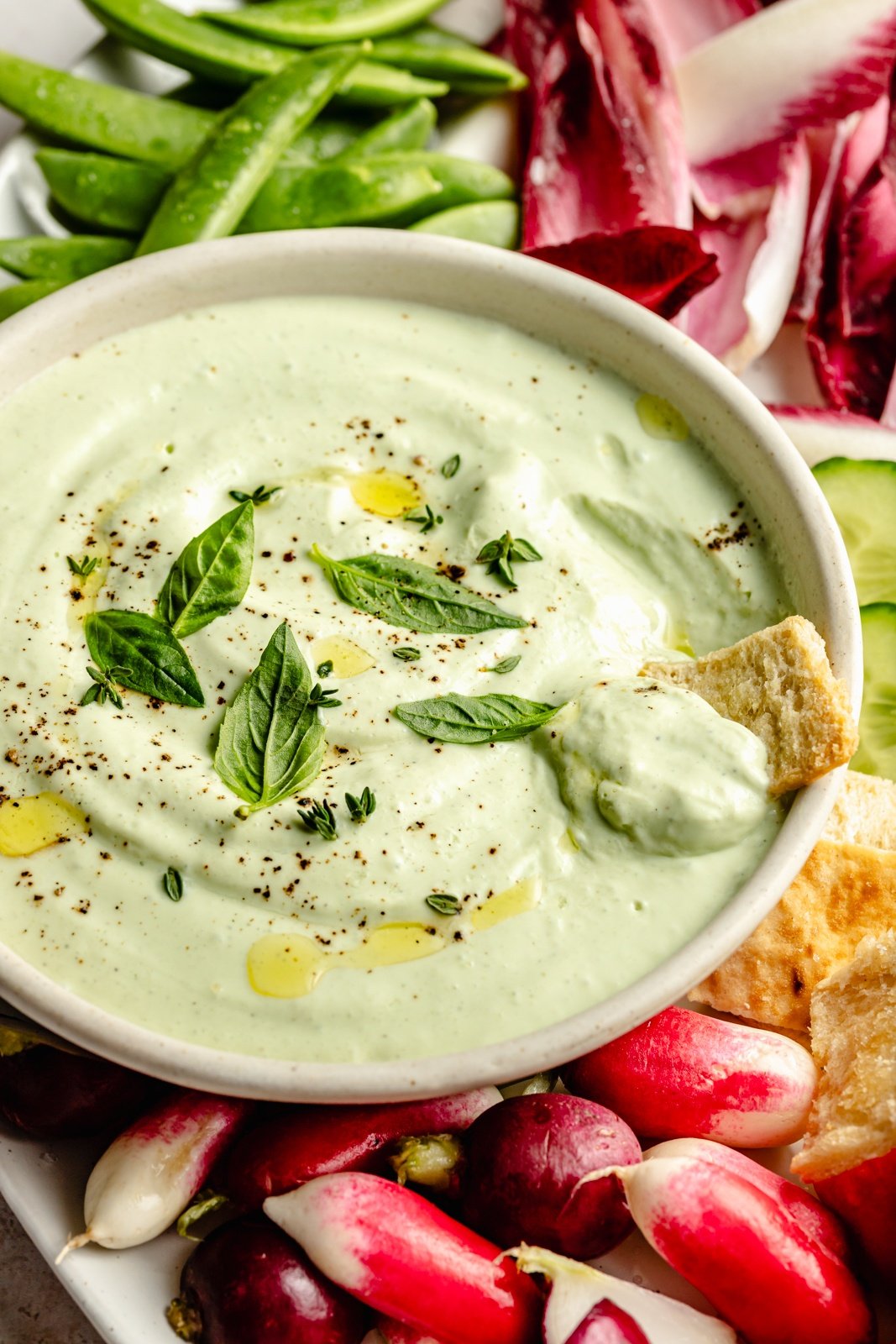 healthy whipped cottage cheese dip in a bowl with a pita cracker