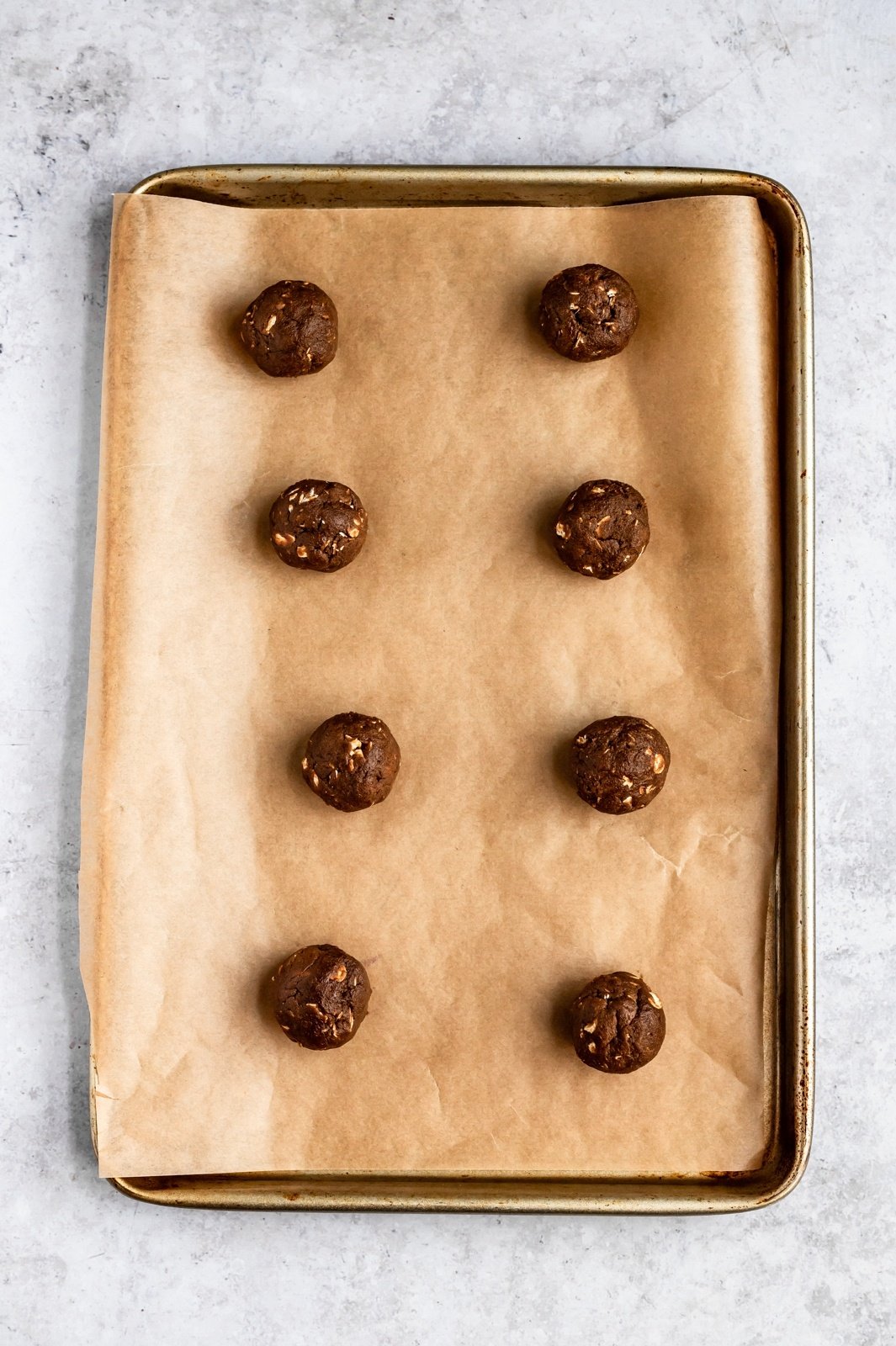 gingerbread oatmeal cookie dough on a baking sheet before being baked