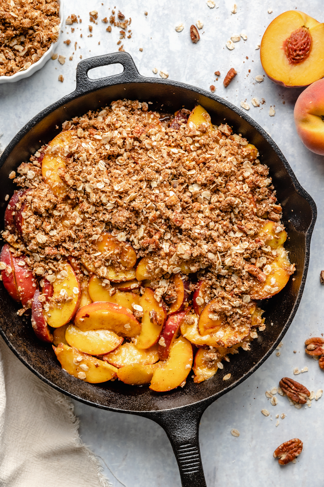 adding peach crisp to a skillet