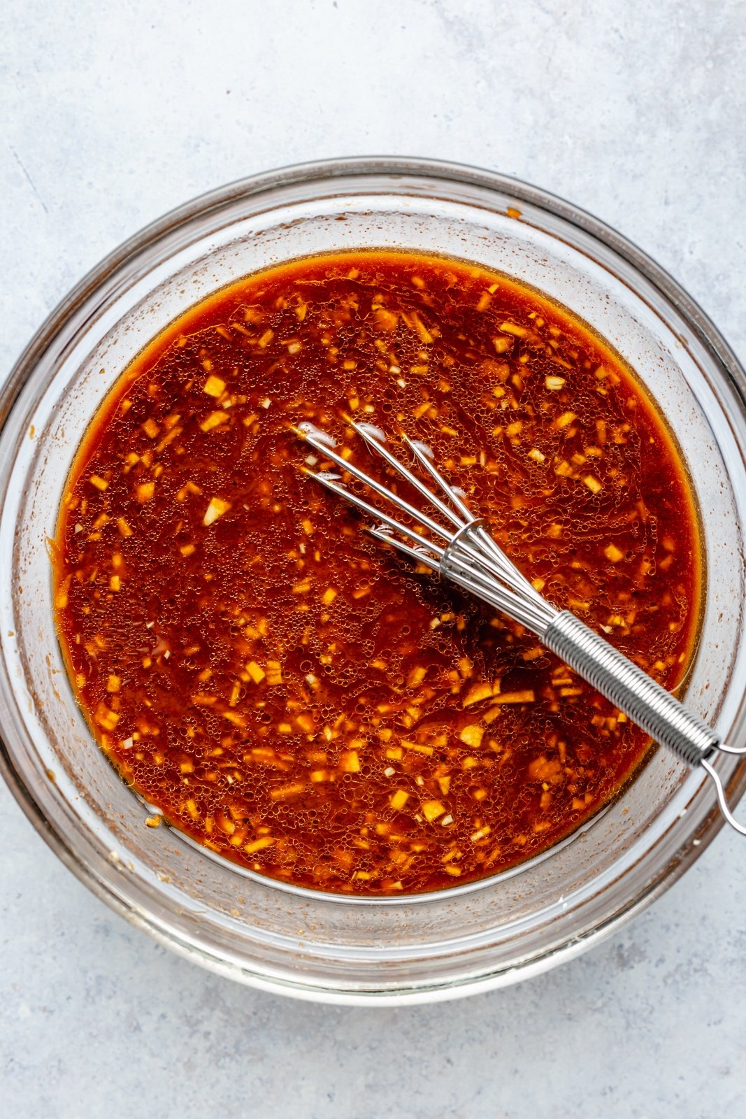 whisking a gochujang sauce for basil chicken bowls