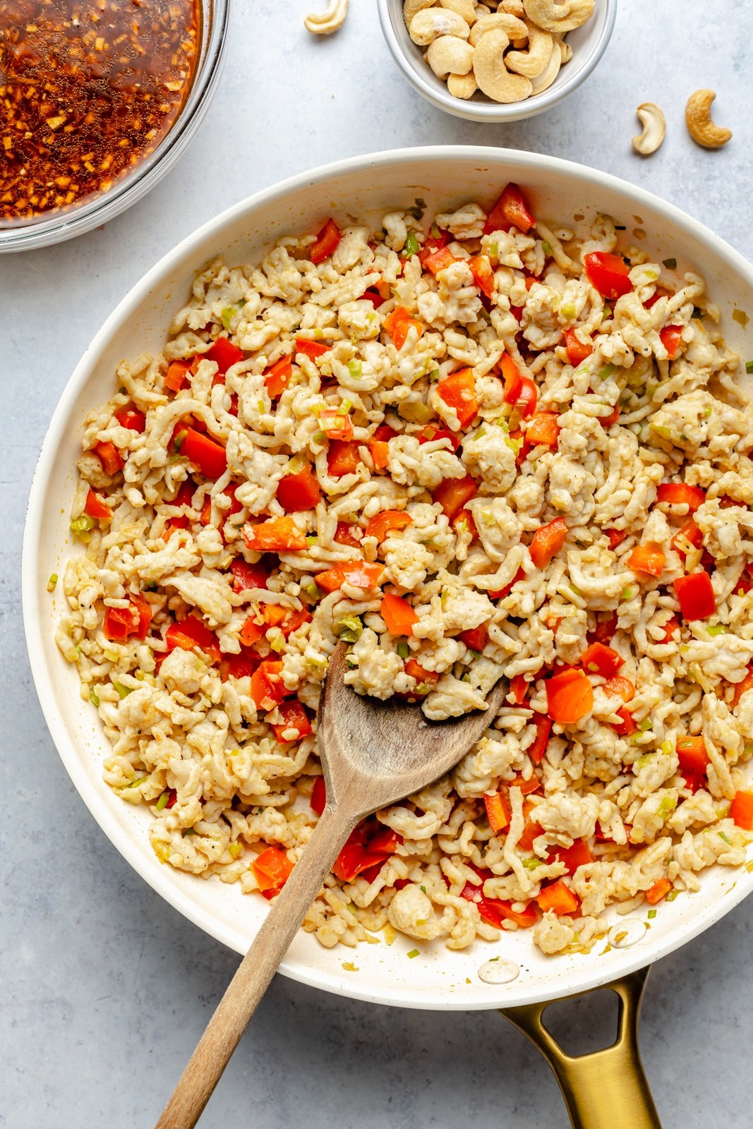 cooking ground chicken and veggies for gochujang chicken bowls