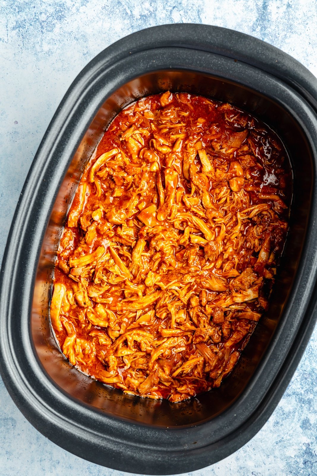 slow cooker gochujang pulled chicken in a crockpot to make sandwiches