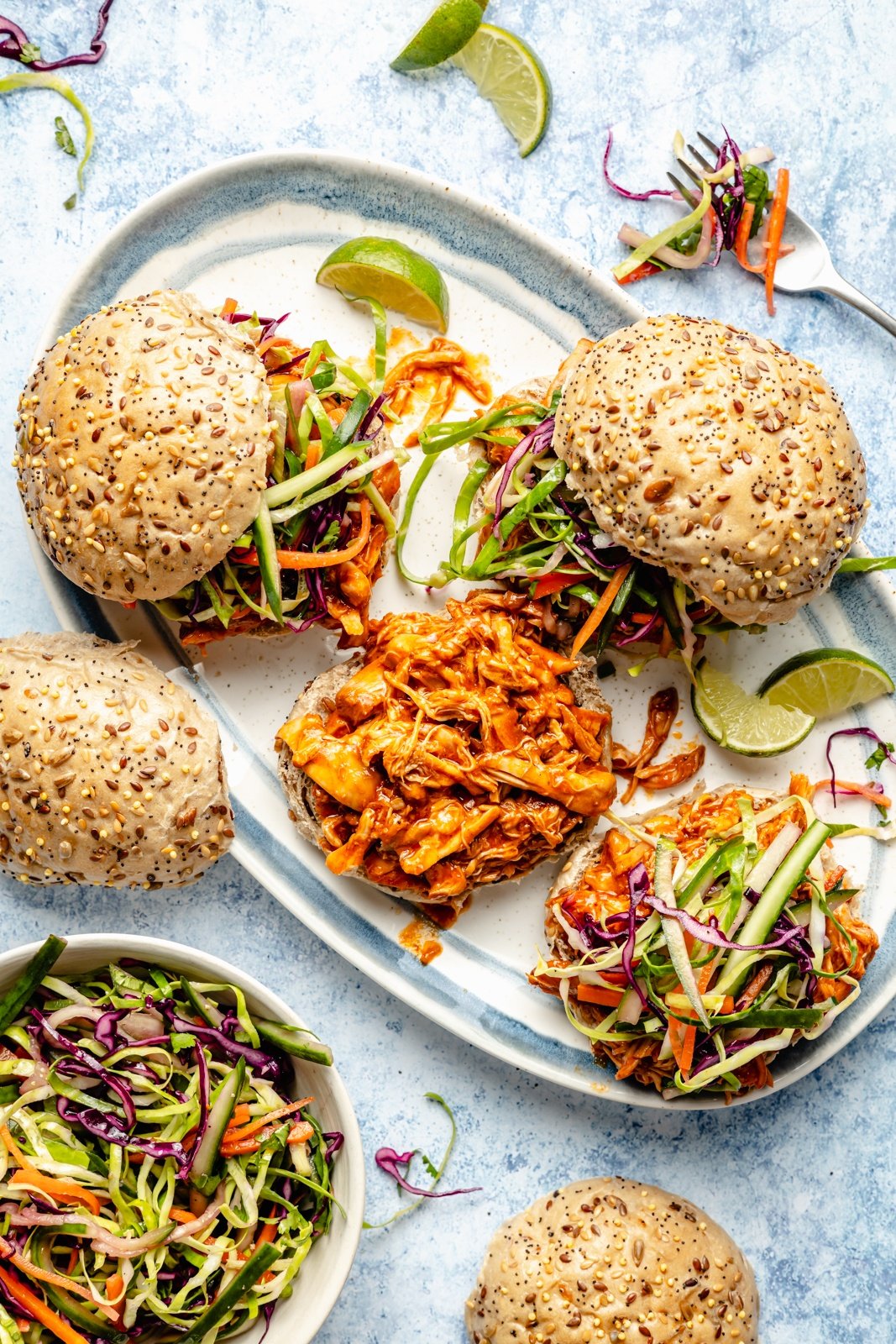 gochujang pulled chicken sandwiches topped with slaw on a platter