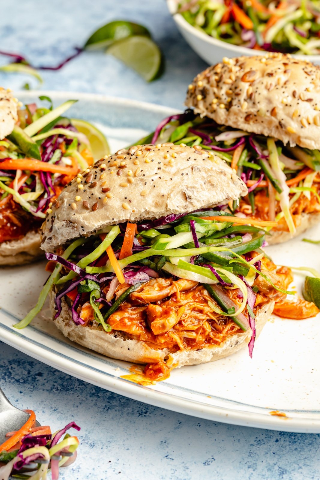 gochujang chicken sandwiches topped with slaw on a platter