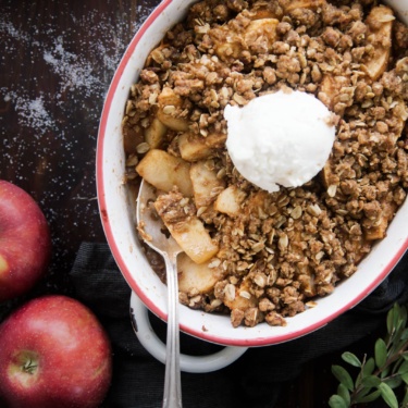 Healthy Apple Crisp in a casserole dish with a spoon