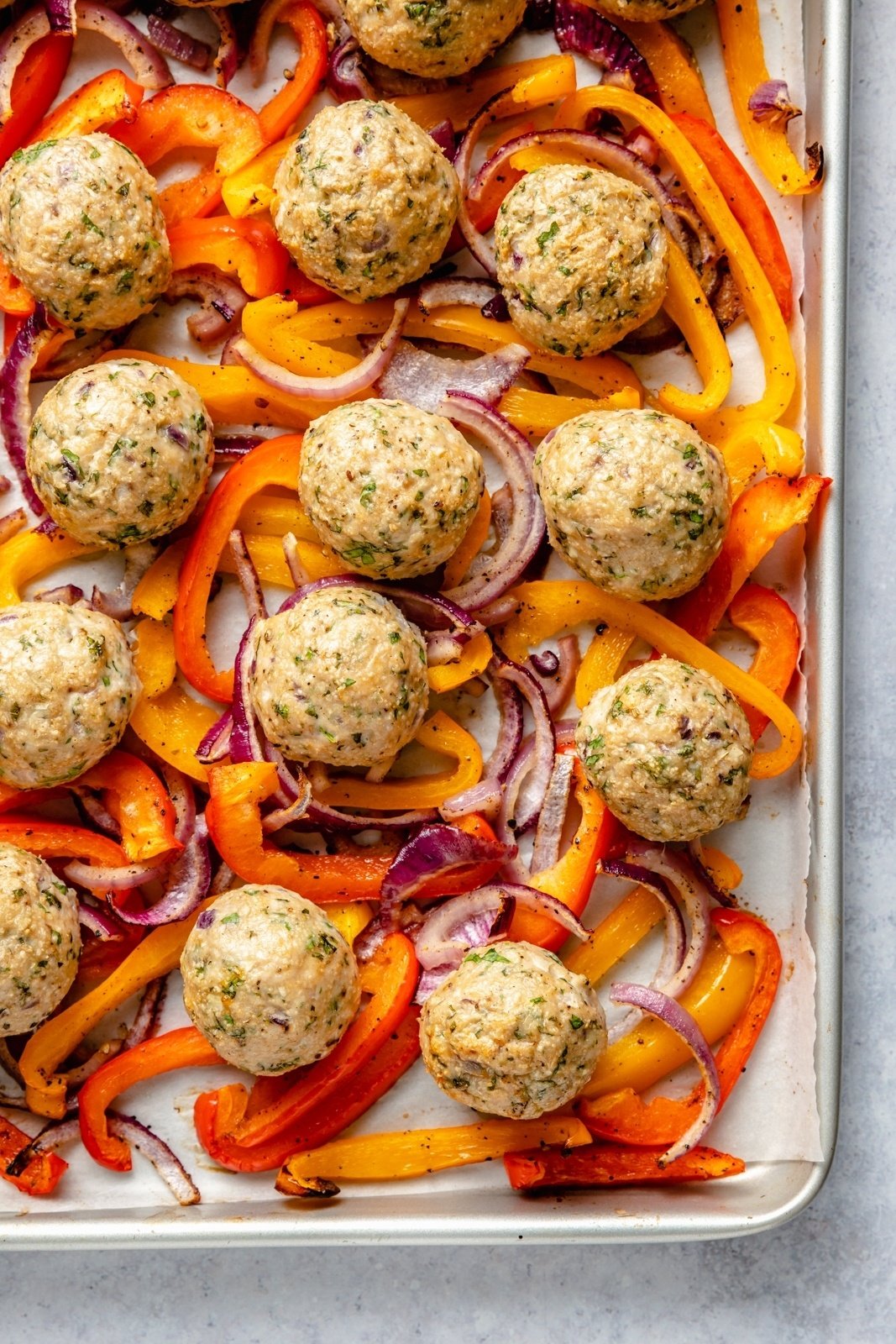 baked Greek turkey meatballs on a sheet pan with peppers