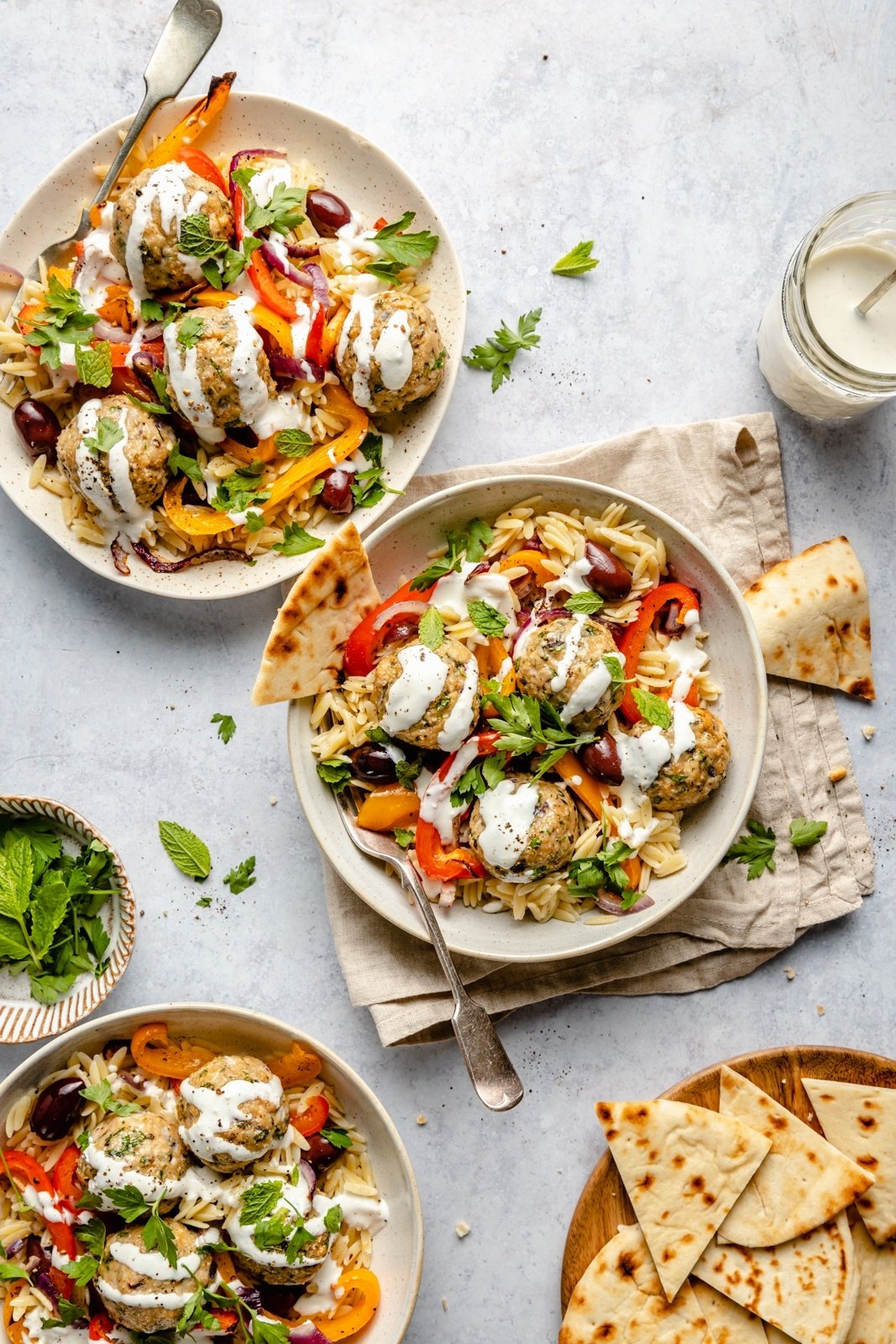 healthy Greek turkey meatballs with orzo in three bowls