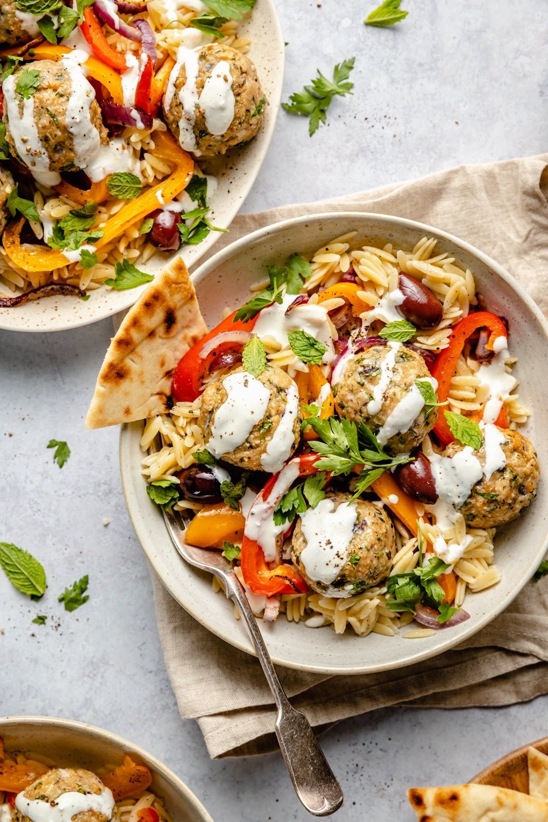 easy Greek turkey meatballs with orzo and feta sauce in bowls