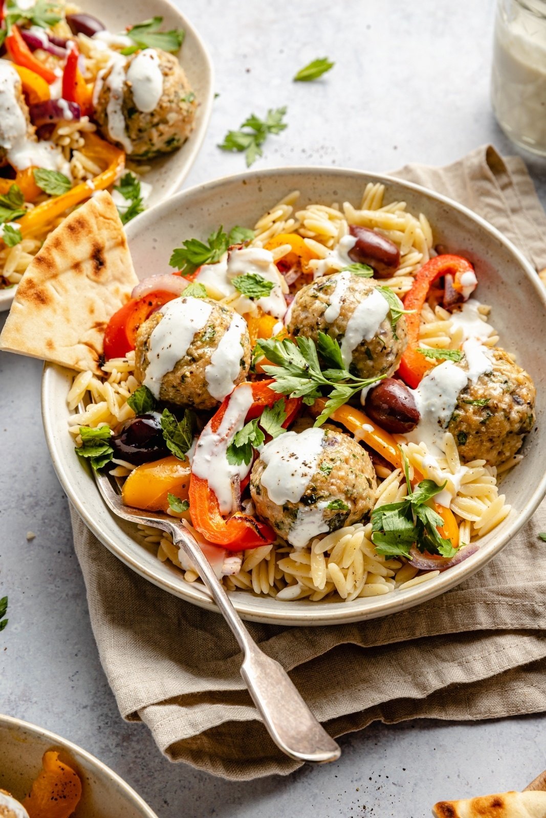 Greek turkey meatballs with orzo and feta sauce in a bowl