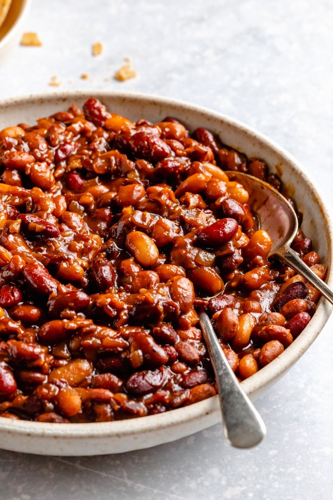 baked beans in a bowl with two spoons