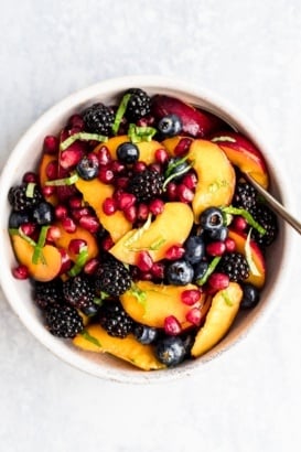 summer peach berry fruit salad in a bowl