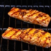 two pieces of salmon on a grill