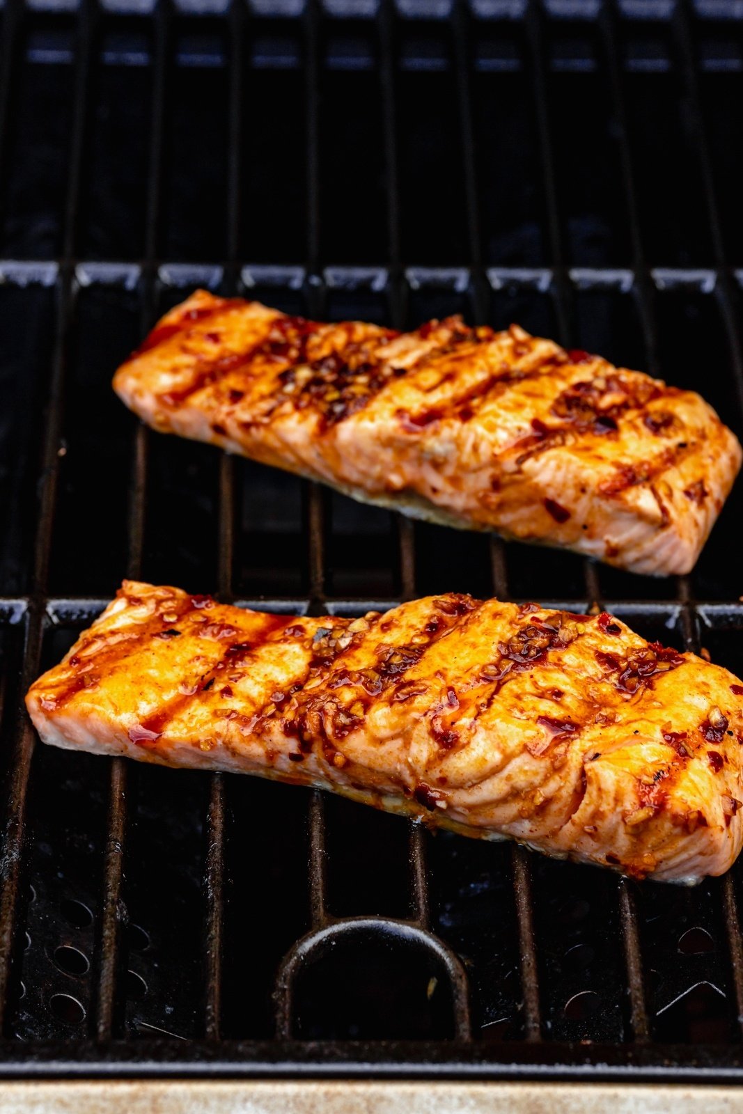 two pieces of salmon on a grill