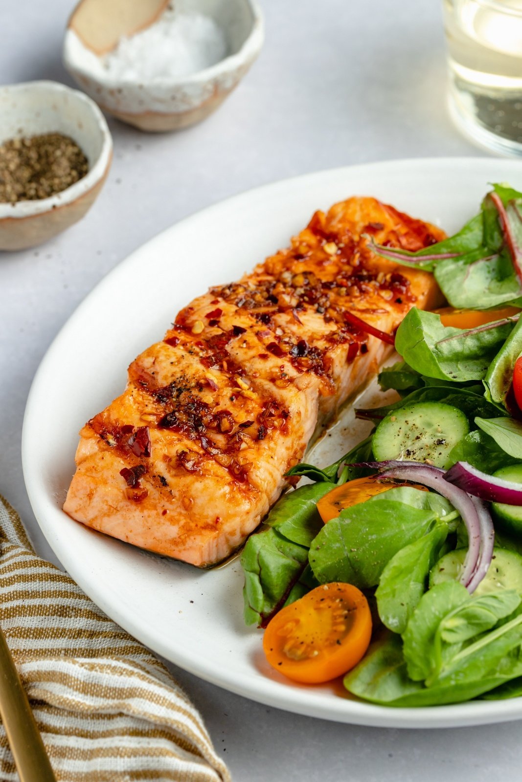 grilled salmon on a plate with a salad