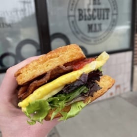 holding a biscuit breakfast sandwich