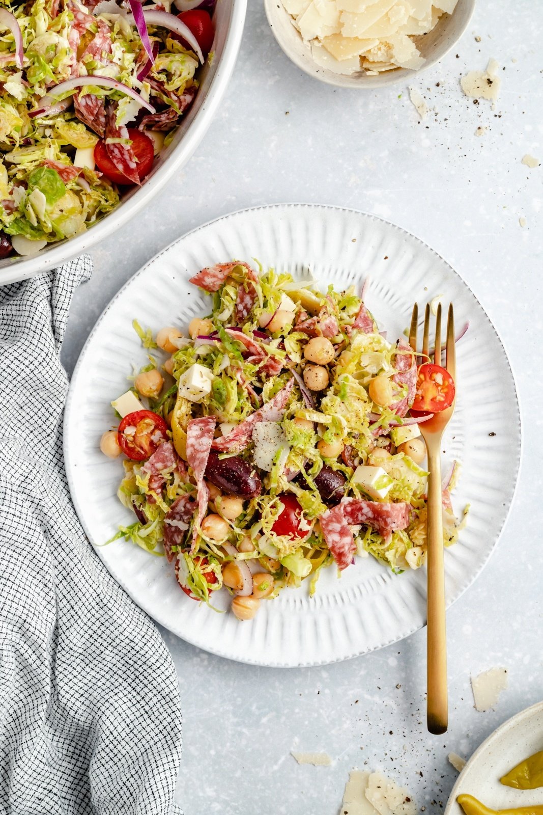 healthy italian chopped brussels sprouts salad on a plate with a fork