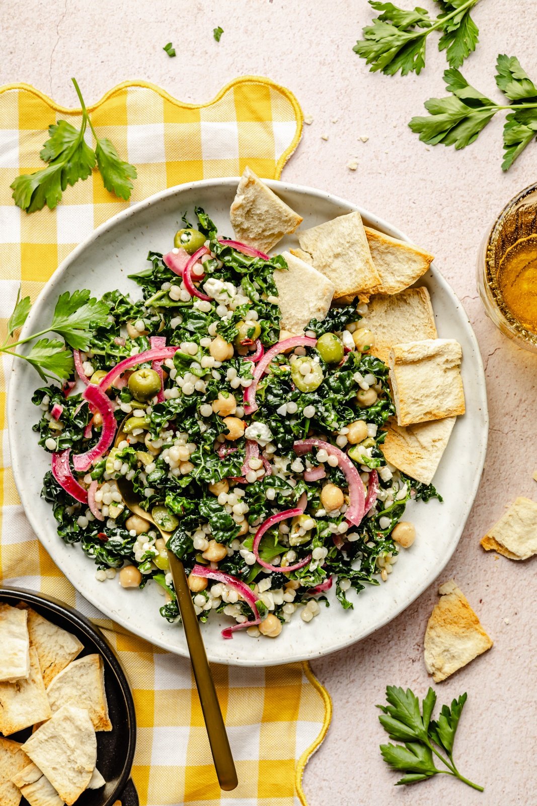 vegetarian kale couscous salad on a plate with pita chips