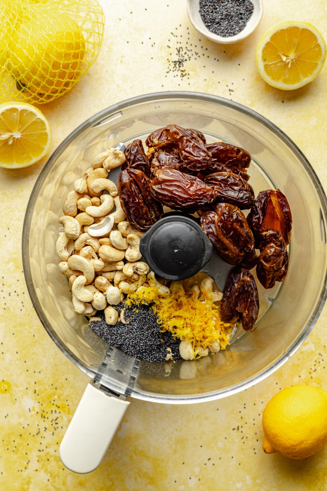 ingredients for lemon energy bites in a food processor