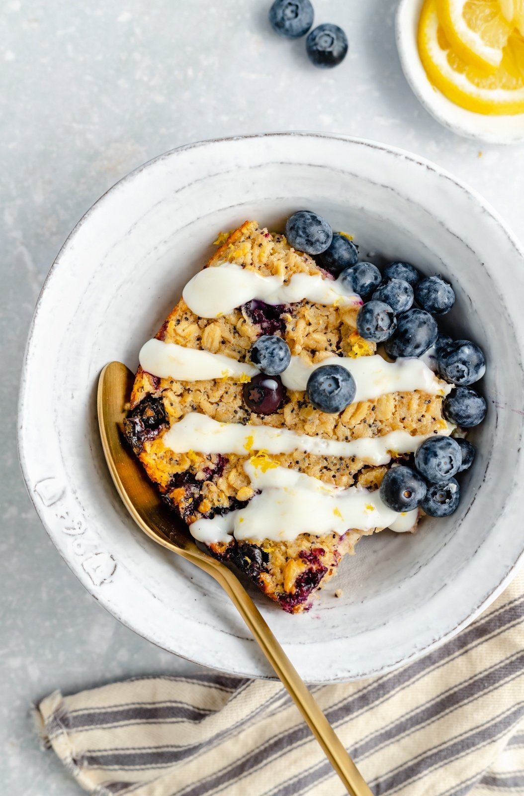 lemon blueberry oatmeal bake in a bowl with blueberries