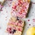 paleo lemon blueberry bread with pink glaze next to a lemon