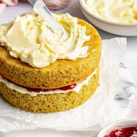 frosting a cake with lemon buttercream