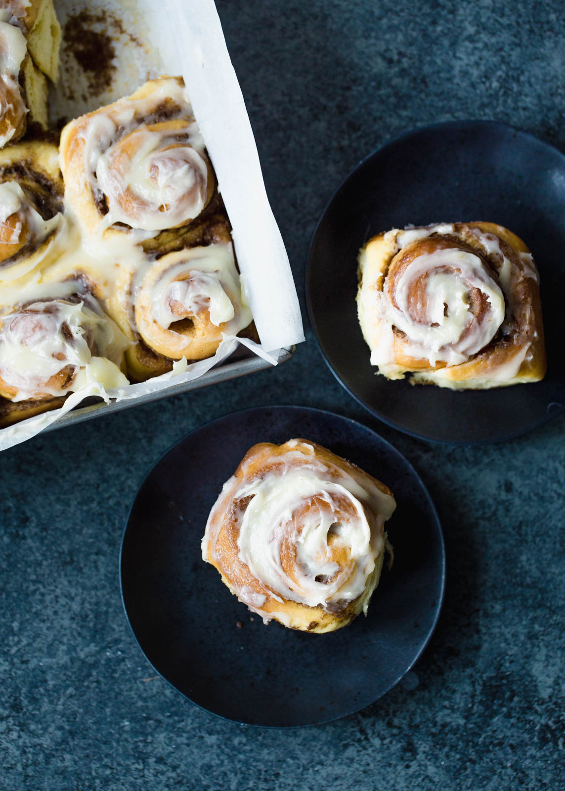 two cinnamon rolls made from scratch on a plate