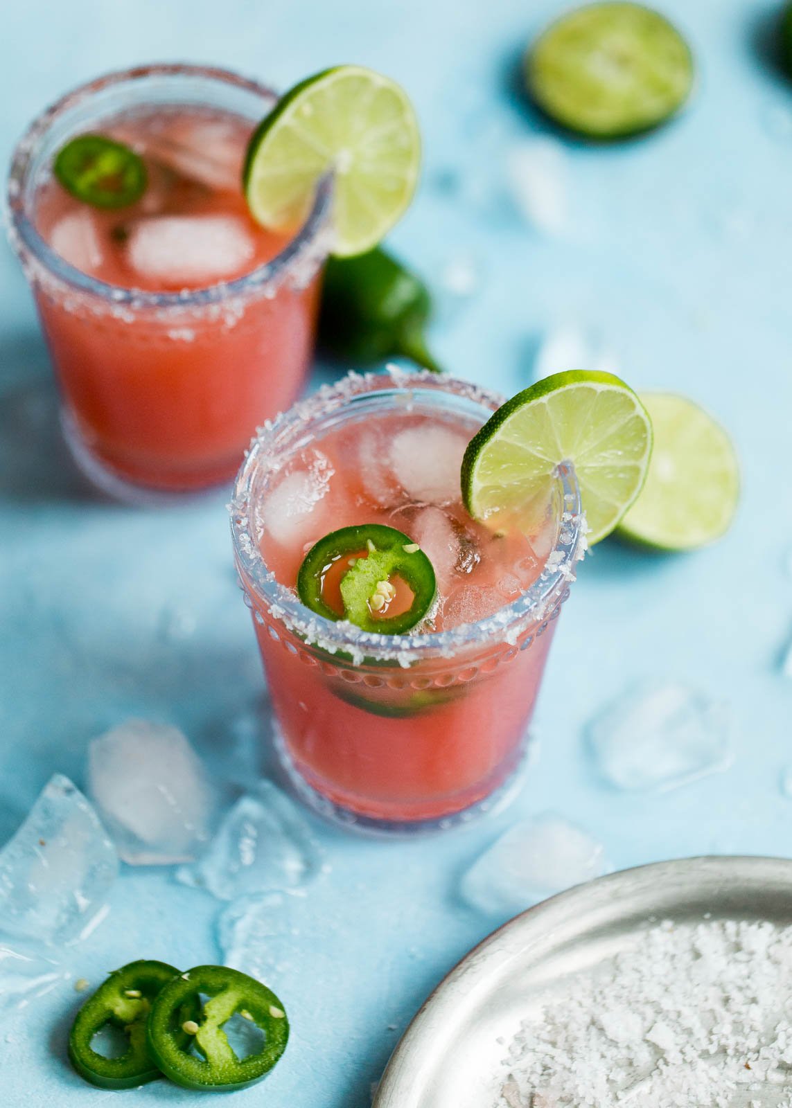 Skinny Jalapeño Watermelon Margaritas in two glasses with lime and jalapeño slices